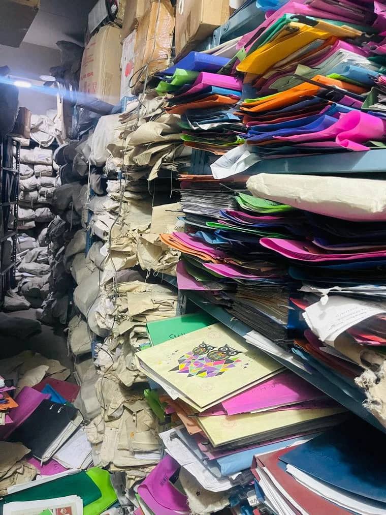 Files and folders piled in a disorganised storeroom