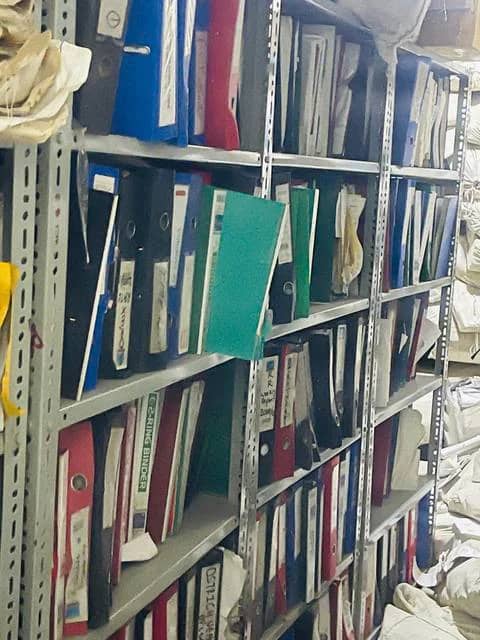 Shelves of labelled lever-arch binders